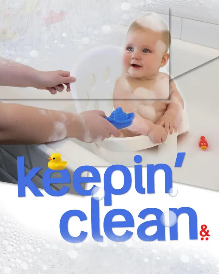 happy baby sitting in bath tub supported by poppy bath seat while mum entertains - phil and teds